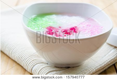 Tub Tim Krob ,Stuffed Water Chestnut in Syrup and Coconut Milk on wood table