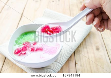 Tub Tim Krob ,Stuffed Water Chestnut in Syrup and Coconut Milk on wood table