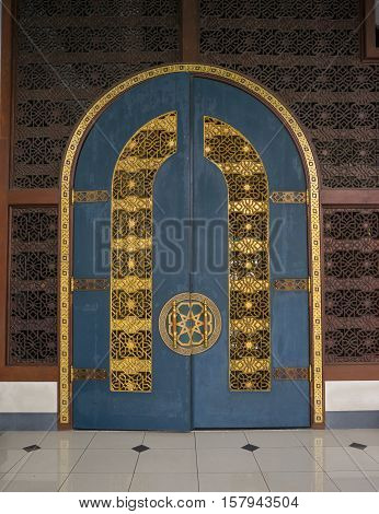 the very big wooden door inside of the biggest mosque in Indonesia