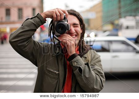 Young photographer taking a photo with DSLR camera