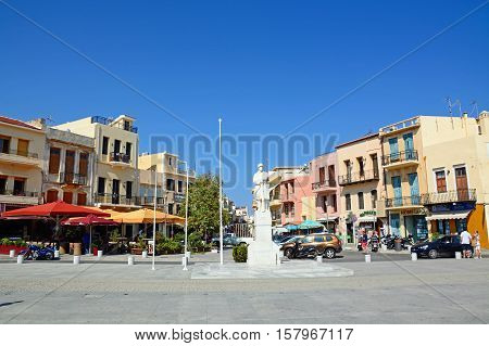 RETHYMNO, CRETE - SEPTEMBER 15, 2016 - Statue to the unknown soldier in Agia Stratiota Square (Agnostou Square) with pavement cafes to the rear Rethymno Crete Greece Europe, September 15, 2016.