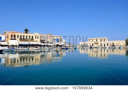 RETHYMNO, CRETE - SEPTEMBER 15, 2016 - View of fishing boats and waterfront restaurants in the inner harbour Rethymno Crete Greece Europe, September 15, 2016.