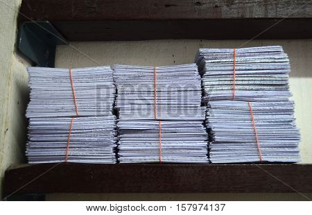 A Pile Of White Cut Papar With Rubber Band