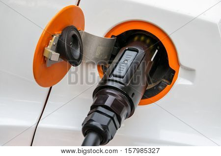 Charging cable with a plug in socket of a electric car