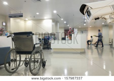 The CCTV security camera operating in office hospital blur background.