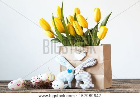 Easter Background Yellow Tulips On Wooden Table, Rabbit, Eggs,nest Candy