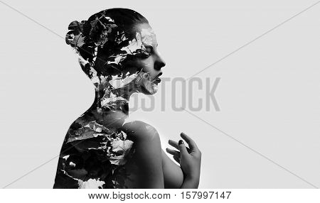 Silhouette of a woman combined with a autumn maple leaves. Double exposure isolated on a white background