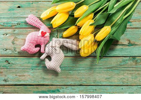 Easter Background Yellow Tulips On Wooden Table, Rabbit, Eggs,nest Candy