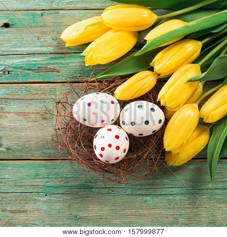 Easter Background Yellow Tulips On Wooden Table, Rabbit, Eggs,nest Candy
