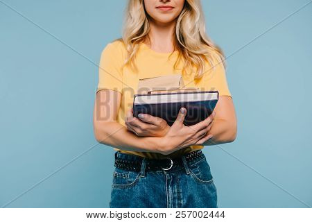Cropped Image Of Girl Holding Books Isolated On Blue