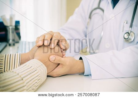 Friendly Man Doctor Hands Holding Patient Hand Sitting At The Desk For Encouragement, Empathy, Cheer