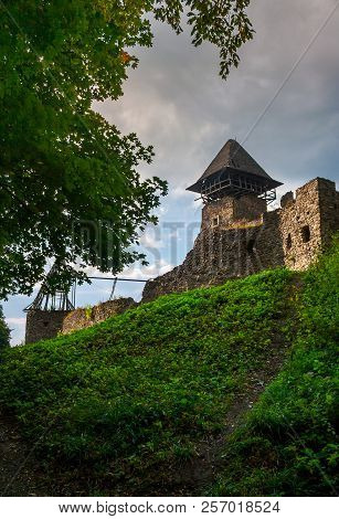 Ruins Of Nevytsky Castle On Grassy Hill. Medieval Fortress Is Popular Tourist Destination Of Transca