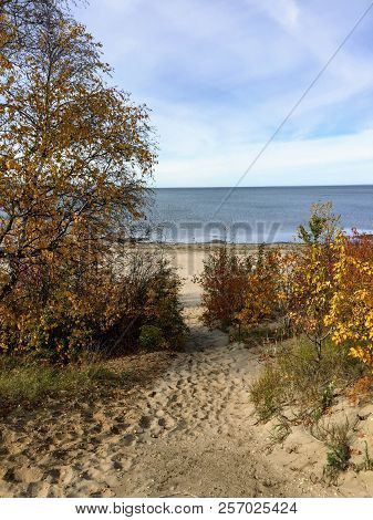 A Sandy Pathway Through The Autumn Foliage Leading To The Still Beautiful Waters Of Slave Lake In No