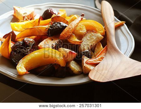 Grilled Fall Seasonal Vegetables On Plate Over A Dark Background