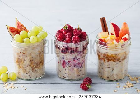 Assortment Overnight Oats, Bircher Muesli With Fresh Berries And Fruits In A Glass Jars On Wooden Ta