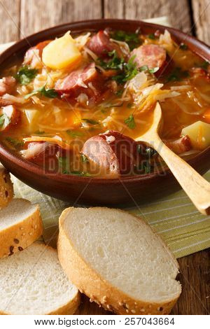 Czech Traditional Soup Zelnacka Of Sauerkraut With Sausages Close-up In A Bowl. Vertical