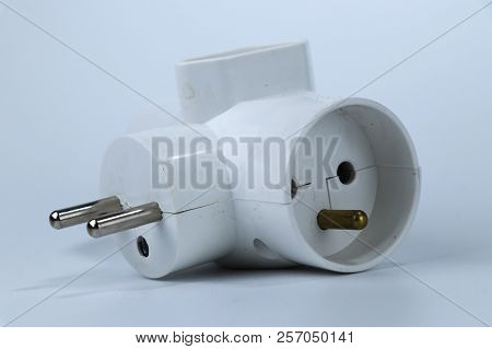 A Three Way Adapter For Connect Another Three Cabels To One European Socket. White Or Grey Backgroun