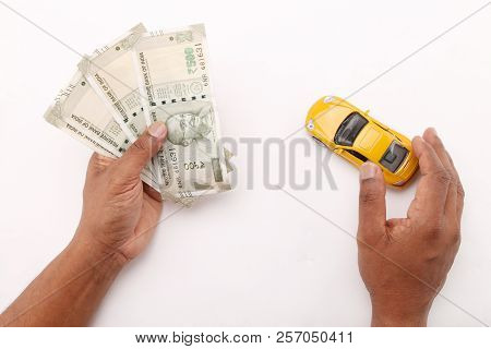 Indian Currency Notes And Toy Car In The Hands Bank Loan Concept