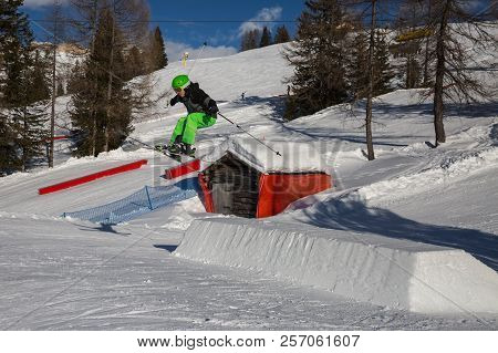 Skier In Action: Ski Jumping In The Mountain Snowpark.