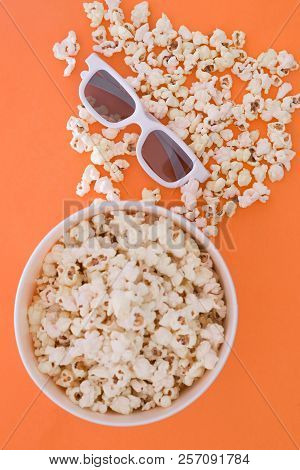 Background. Popcorn, Cup And 3d Glasses On A Colored Orange Background. Flat Lay. Copyspace. Cinema 