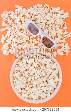 Cup With Popcorn And 3d Glasses On A Orange Background, Top View. Cinema Concept. Flat Lay. Copyspac