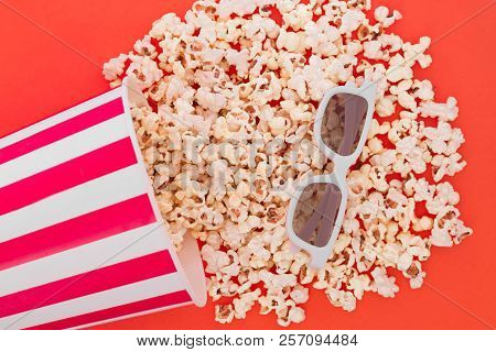 Popcorn Pouring From A Paper Bowl To A Red Background, And 3d Glasses For Watching The Movie, A Top 