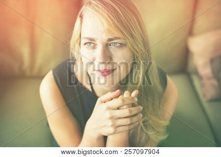 Portrait Romantic Fair Hair Young Beautiful Woman With Blue Yeys In Black Dress Green Sofa