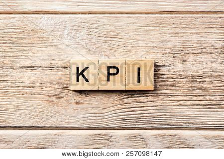 Kpi Word Written On Wood Block. Kpi Text On Table, Concept.
