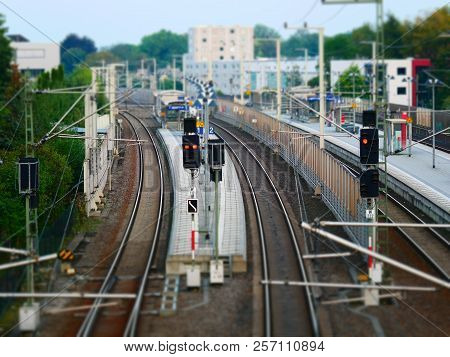 Tilt Shift Picture Of A Railroad Platform With Signal Lights