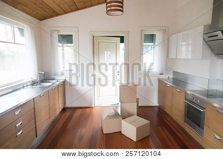 Stack Of Cardboard Boxes In New Modern Kitchen