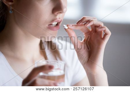 Close Up Of Unhealthy Woman Taking Painkiller Pill