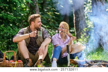 Couple Take Break To Eat Nature Background. Couple In Love Camping Forest Hike. Couple Sit Near Bonf