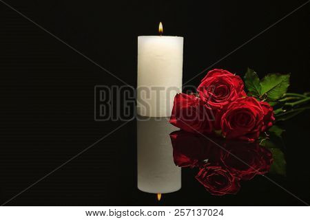 Beautiful Red Roses And Candle On Black Background. Funeral Symbol