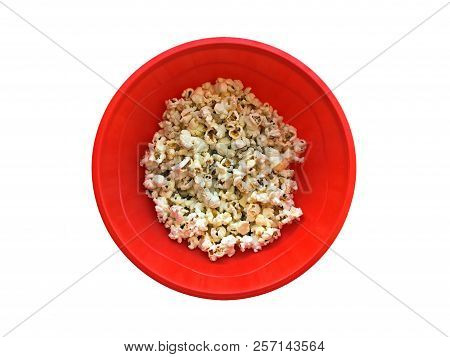 A Red Plastic Bowl With Popcorns Isolated On White Background