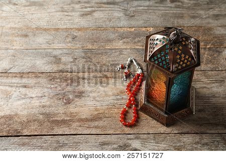 Muslim Lamp And Misbaha On Wooden Background. Fanous As Ramadan Symbol