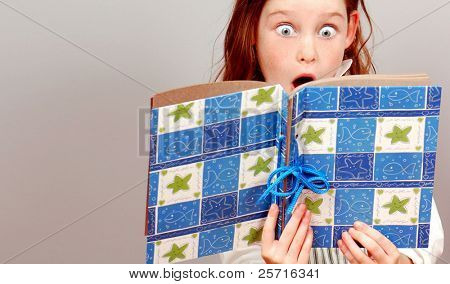 Young Girl With Huge Eyes in Exclamation Over What She's Reading