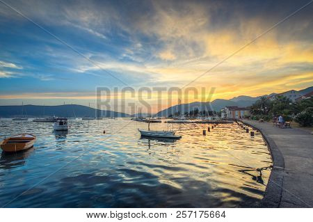 The Sky At Sunset Reflects In The Mother-of-pearl Water Surface, On Which Lonely Boats Wander. Order