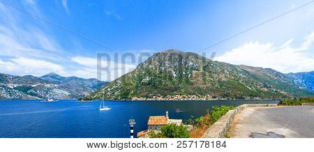 The Giant Mountain, At The Foot Of Which Small Houses Have Accumulated, Is Reflected In The Brightly