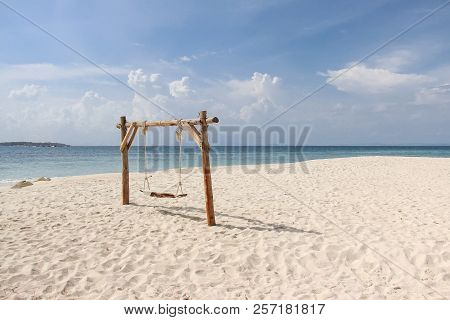 Wooden Swing On The Sand Beach For Summer Holiday Concept.