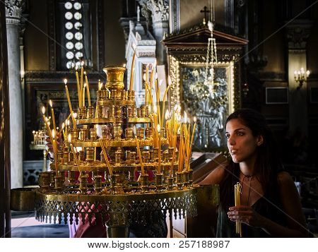 Athens, Greece - June 30, 2018. Parishioner Light Candles In The Nave Of The Metropolitan Cathedral 