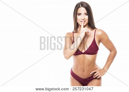 Woman Requires Silence. Young Beautiful Woman In Bikini Put Forefinger To Lips As Sign Of Silence