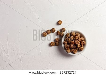 Tigernuts / Earth Almonds / Nutsedges In A Small Bowl, On White Surface, Top View, Copy Space