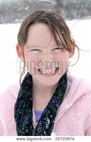 Young girl having fun in fresh snow