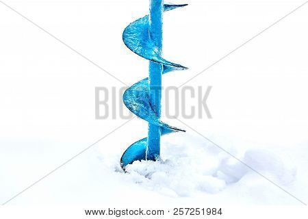 Hand Operated Ice Auger Used In Ice Fishing. Blue Metal Screw. Drill. Hobbies, Winter Fishing On Sno