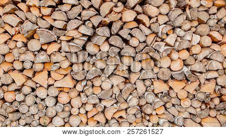Material For Heating The House. Preparation Of Firewood For The Winter. Background Of Firewood. A Pi