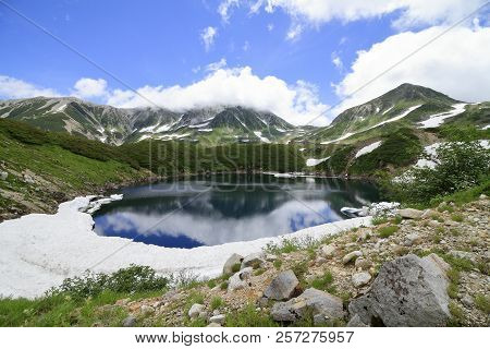 Mikurigaike Pond And Tateyama Mountain Range With Snow In Summer In Toyama, Japan