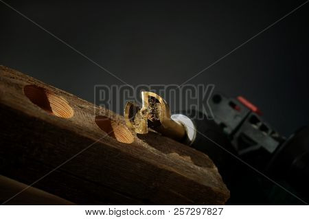 Forstner Bit For Drilling Circular Holes With A Portable Drill Sitting On Top Of Wooden Block Over B