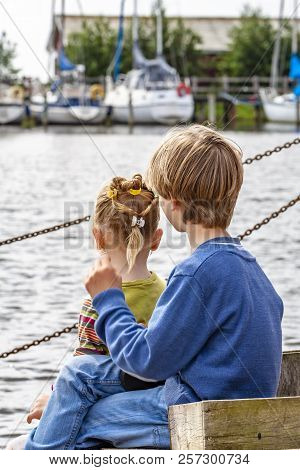 Brother And Sister Enjoying Their Vacation In The Harbour