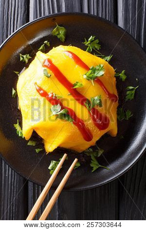 Recipe For Japanese Omelette With Rice, Chicken, Vegetables And Tomato Sauce On A Plate On A Wooden