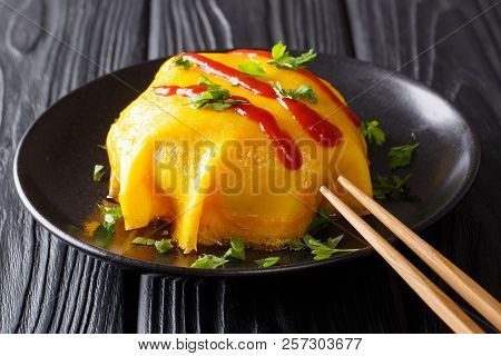 Japanese Menu. Omurice Spicy Omelette With Rice, Chicken, Vegetables And Tomato Sauce On A Black Pla